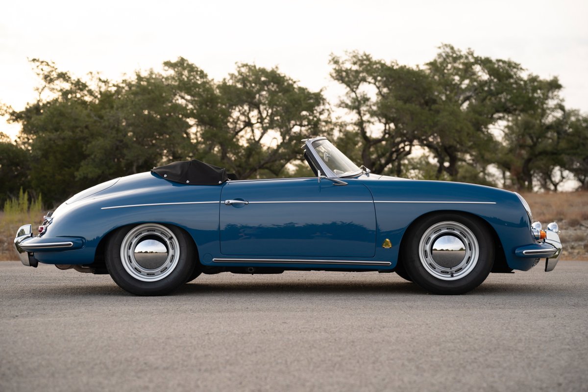 1960 Porsche 356B Roadster in Royal Blue, featuring chrome hubcaps and a black convertible top.