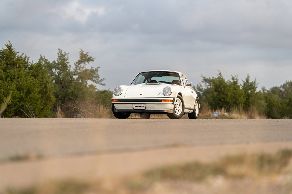 White 1974 Porsche 911 coupe with Fuchs rims and black trim.