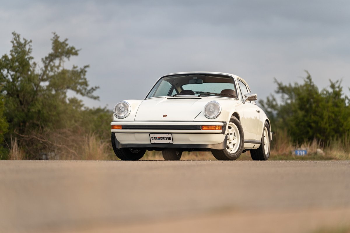 White 1974 Porsche 911 Coupe with classic Fuchs rims.