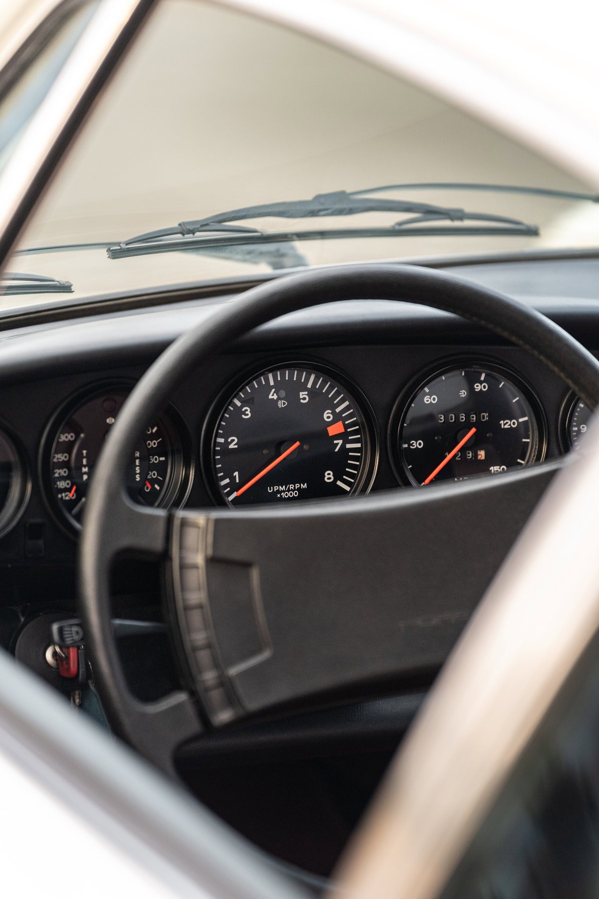 1974 Porsche 911 Coupe interior, close-up on the tachometer and speedometer.