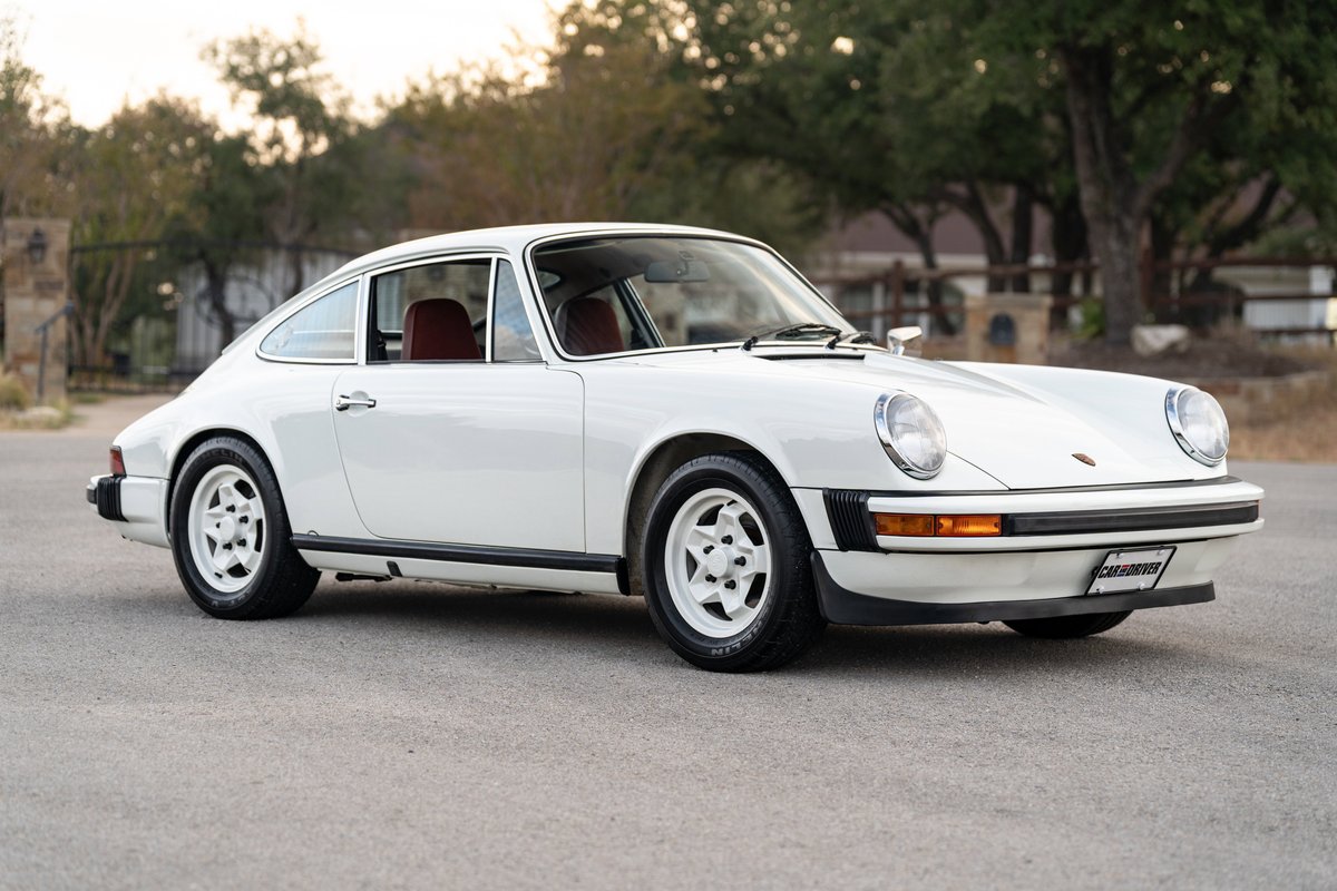 1974 white Porsche 911 coupe with classic Fuchs rims and black trim.