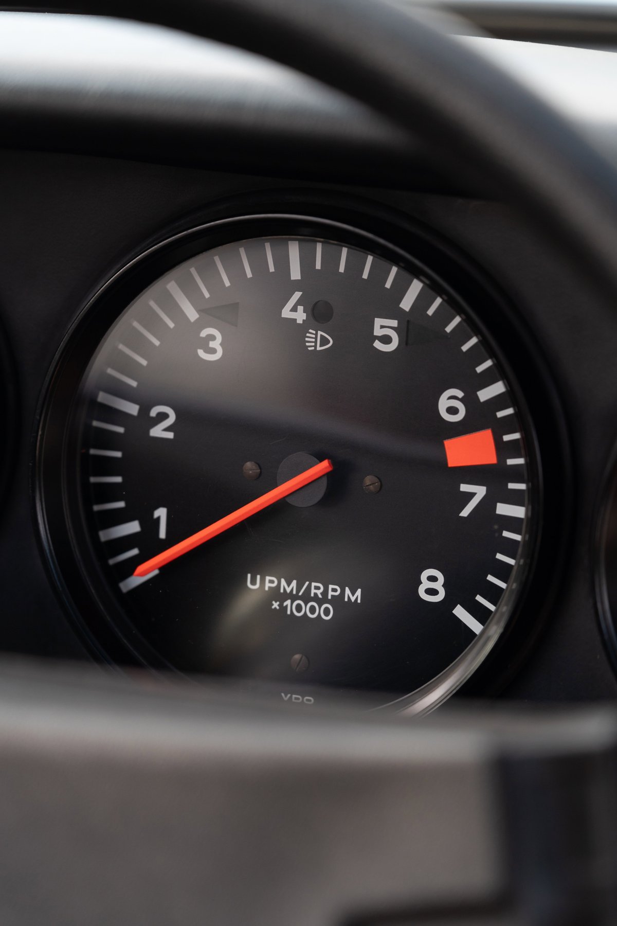 1974 Porsche 911 Coupe tachometer shows 7000 RPM redline, VDO gauge.