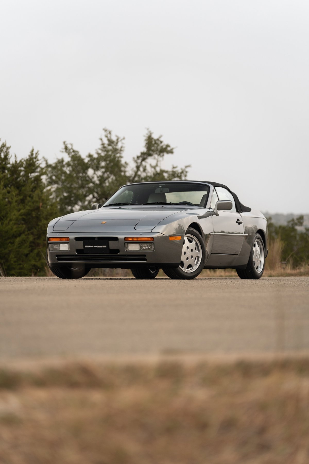 1990 Porsche 944 S2 Cabriolet in Titanium Metallic, front 3/4 view with silver alloy rims.