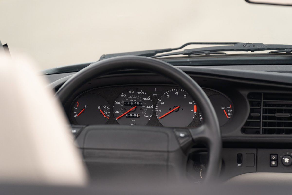 1990 Porsche 944 S2 Cabriolet dashboard. Black interior, analog gauges, and steering wheel.