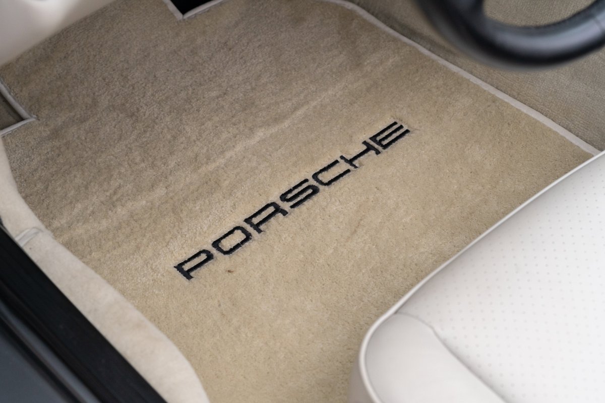 Tan floor mats with embroidered "PORSCHE" logo in a 1990 Porsche 944 S2 Cabriolet.