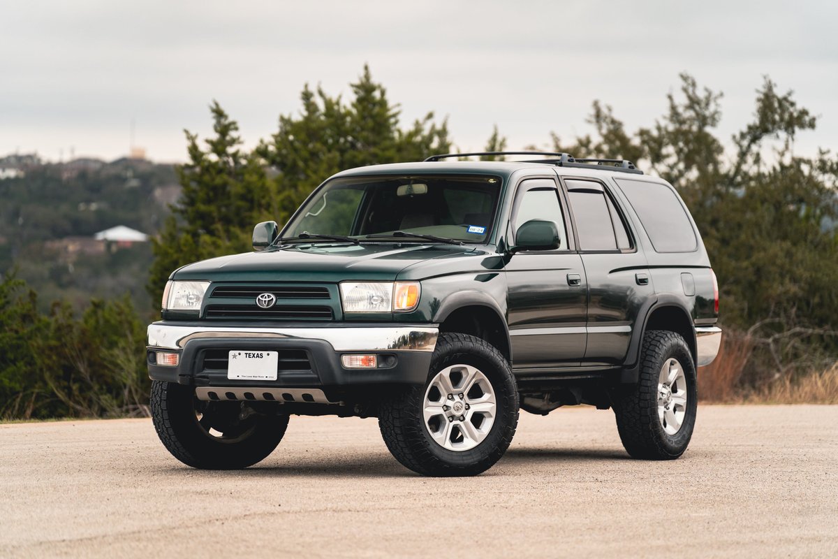 Green 2000 Toyota 4Runner with chrome trim and silver rims.