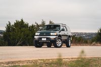 Imperial Jade Mica 2000 Toyota 4Runner with chrome trim and alloy rims on a paved road.
