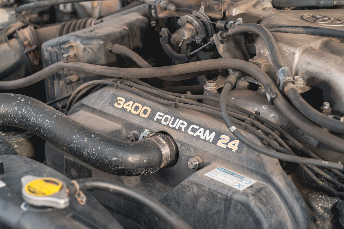Close up of a dusty 3400 Four Cam 24 engine bay in a 2000 Toyota 4Runner.