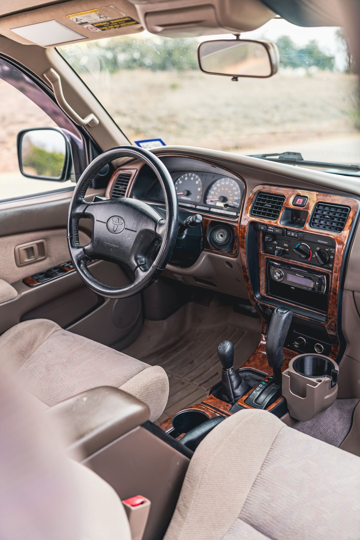 Interior of a 2000 Toyota 4Runner in Imperial Jade Mica, featuring wood trim accents.