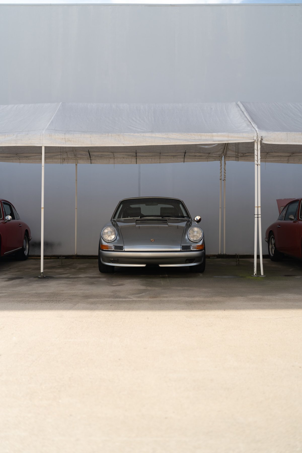 Silver Porsche 911 Targa with chrome trim under a white tent at the Lit Show LA 2024.