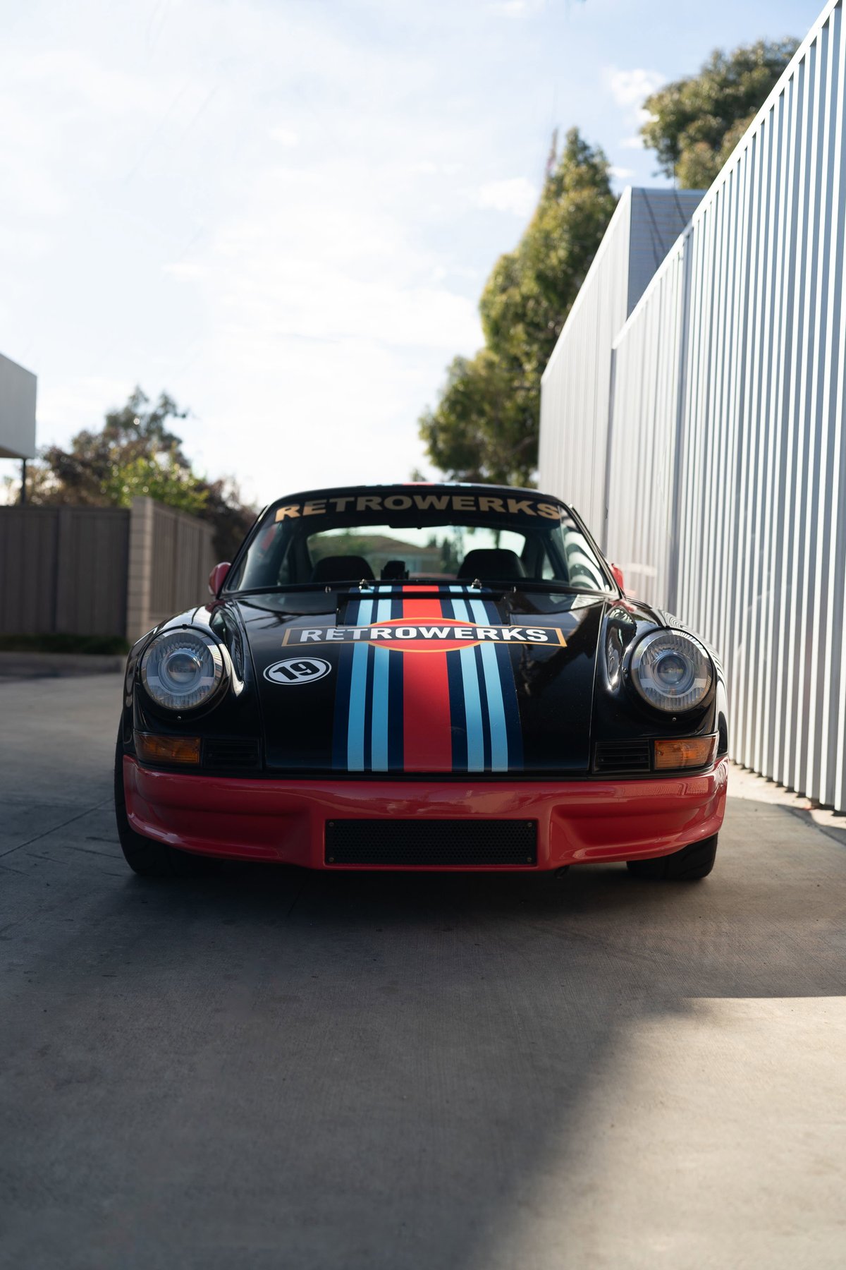Black Porsche 911 with Martini Racing livery, red front bumper, and "RETROWERKS" text.
