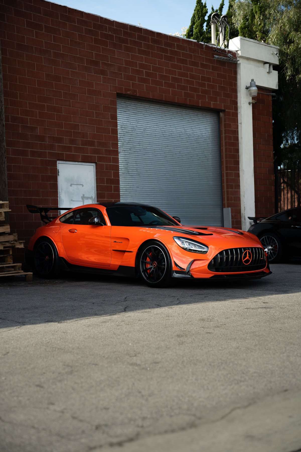 Orange Mercedes-AMG GT Black Series with black aero, carbon fiber trim, and black rims.