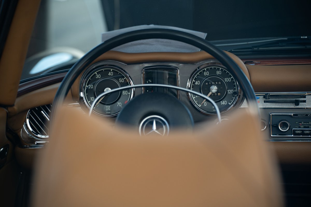 Close-up of the classic Mercedes-Benz 300SL's dashboard with a tan interior.