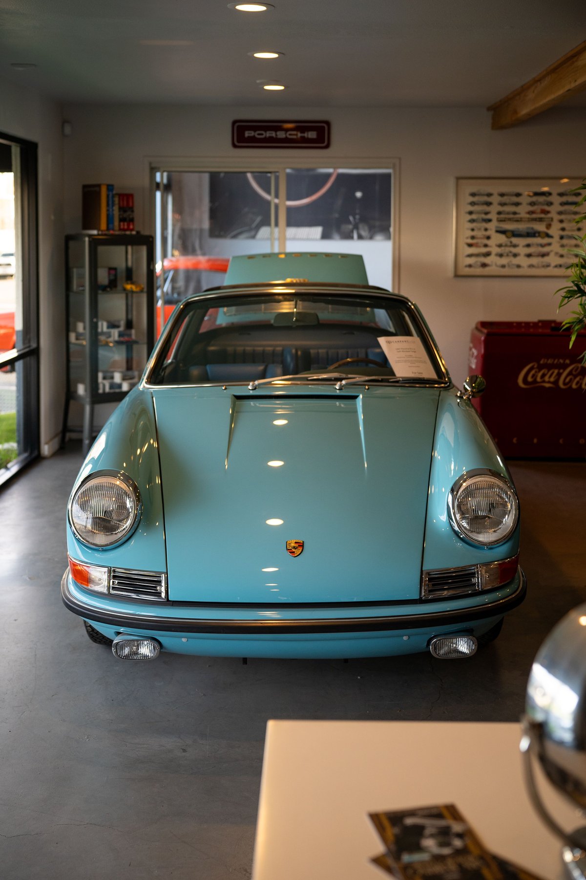 Front view of a light blue 1970s Porsche 911 Targa with chrome trim and bumper guards.