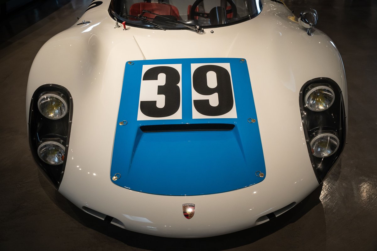 Vintage race car with white body, blue stripe, and "39" livery.