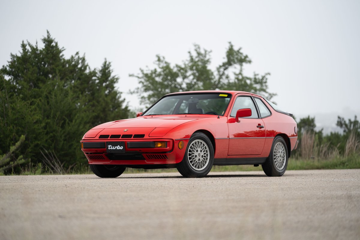 A guards red 1981 Porsche 924 Turbo with alloy rims and black trim.