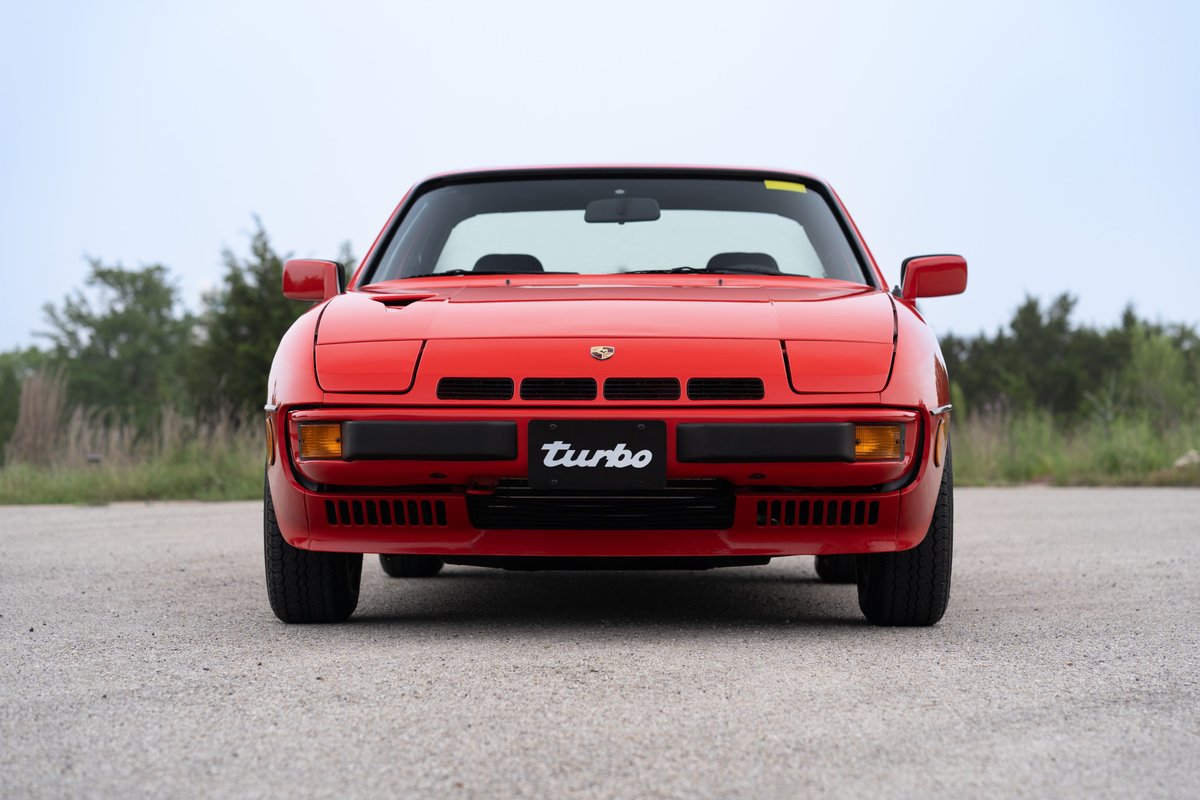 Front view of a Guards Red 1981 Porsche 924 Turbo, featuring black trim and the "Turbo" badge.