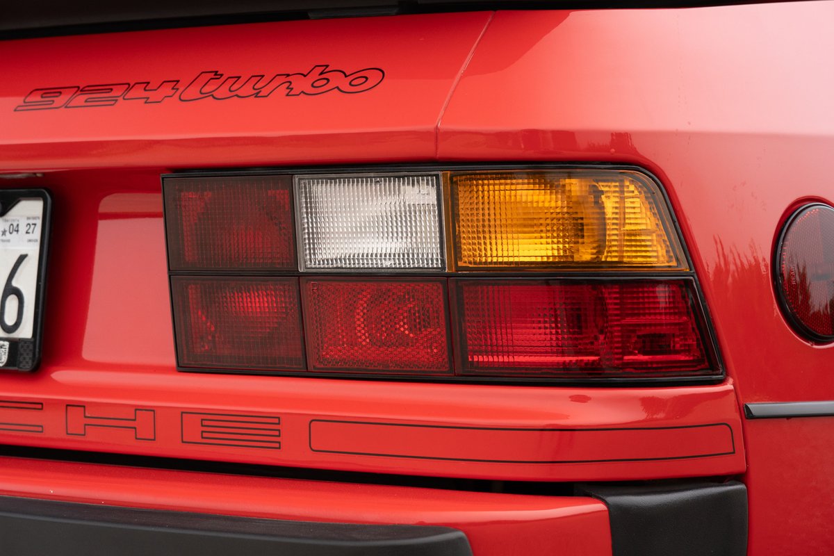 Red 1981 Porsche 924 Turbo rear end. Notice the clear and amber turn signals in the taillight assembly.