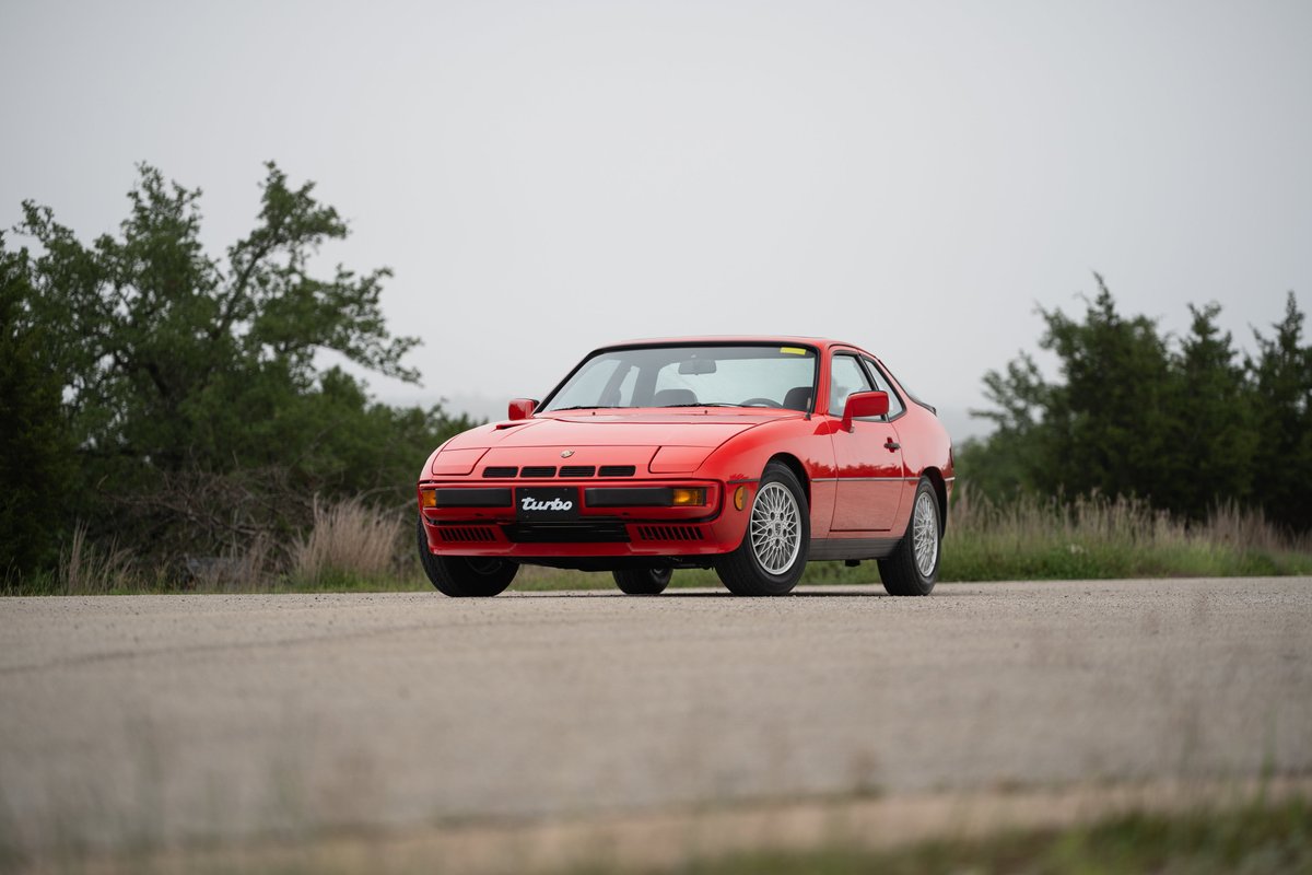 A Guards Red 1981 Porsche 924 Turbo coupe with turbine-style alloy rims.
