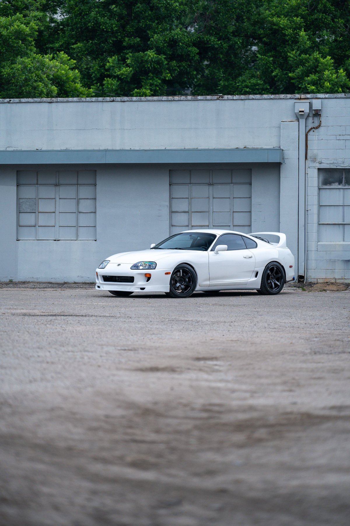 White 1994 Toyota Supra T56 with black rims and body-colored trim.