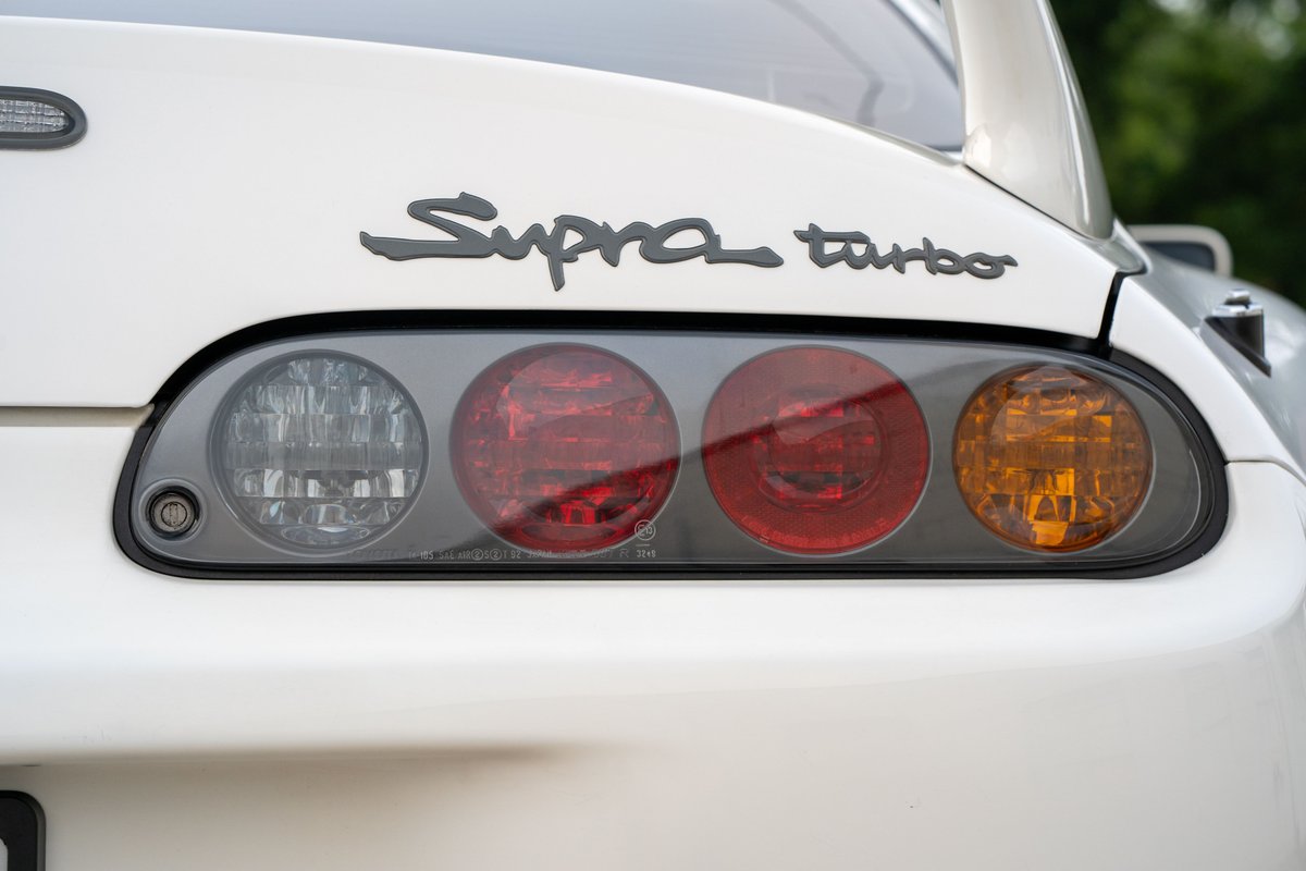 White 1994 Toyota Supra Turbo taillight cluster and badging.