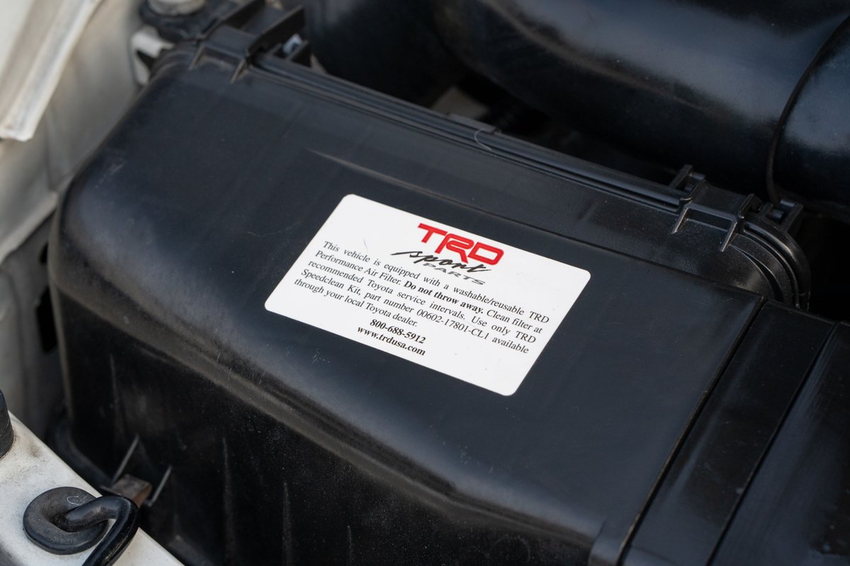 Close-up of the TRD airbox on a white 1994 Toyota Supra.