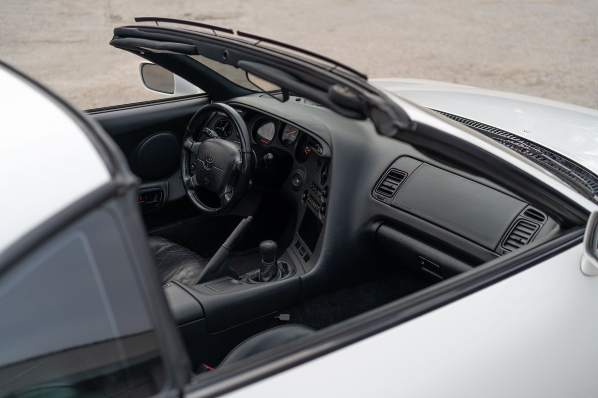 1994 white Toyota Supra interior with black trim and leather seats.
