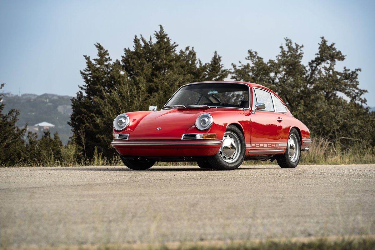 1967 Porsche 912 Coupe in Polo Red, with chrome trim and classic rims.