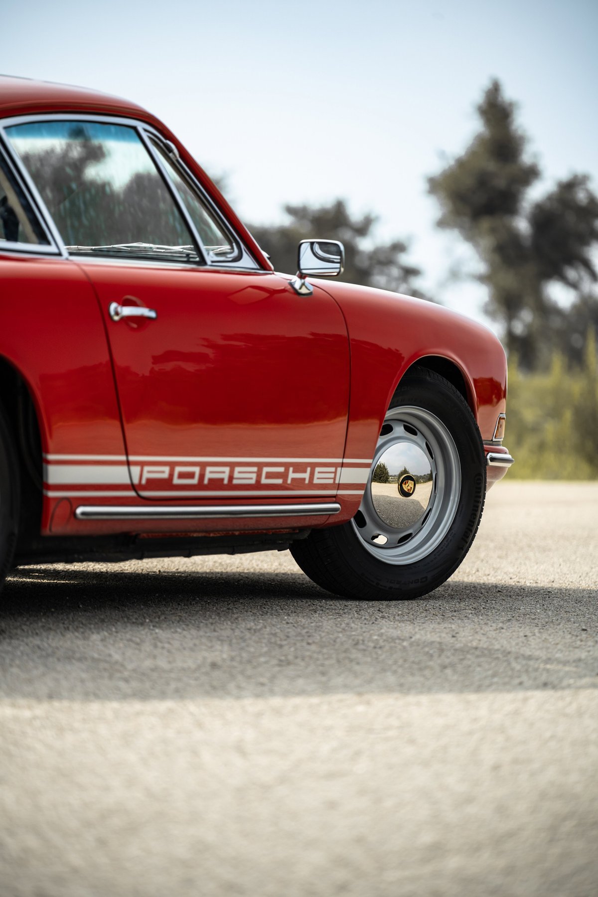 Red 1967 Porsche 912 coupe with chrome trim and "PORSCHE" livery.