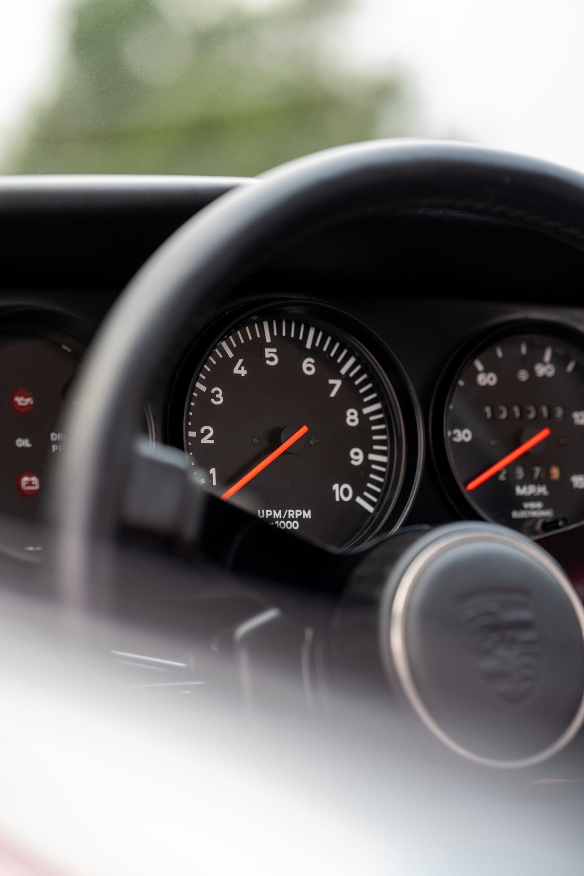 Close-up of the tachometer and speedometer on a 1967 Porsche 912 Coupe dashboard.