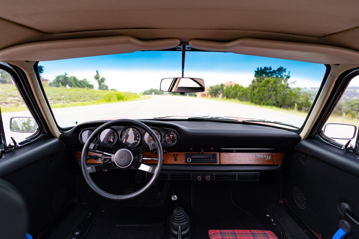 1967 Porsche 912 coupe interior: wooden trim, five-gauge dash, plaid seats.