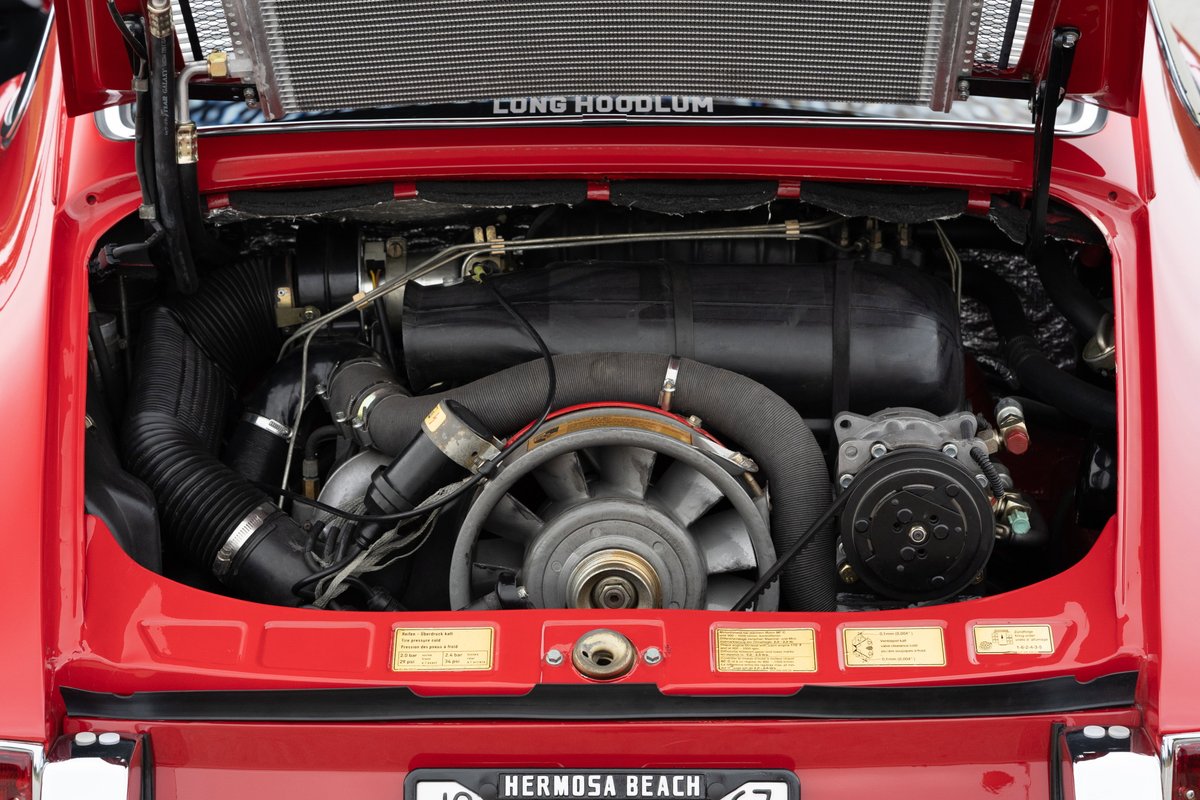 1967 Porsche 912 6-cylinder engine bay in Polo Red. Air-cooled flat-six, fan shroud, AC compressor.
