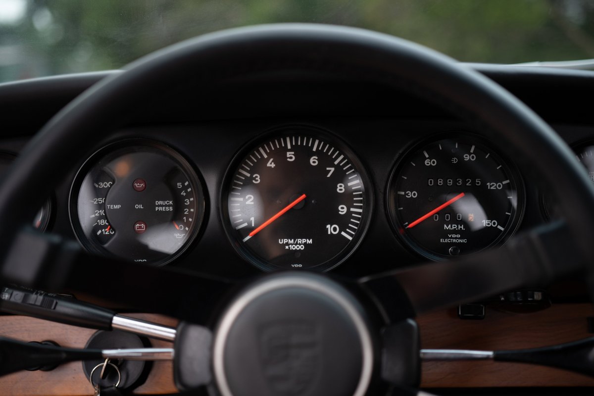 1967 Porsche 912 coupe instrument cluster with tachometer, speedometer, and oil/temp gauges.
