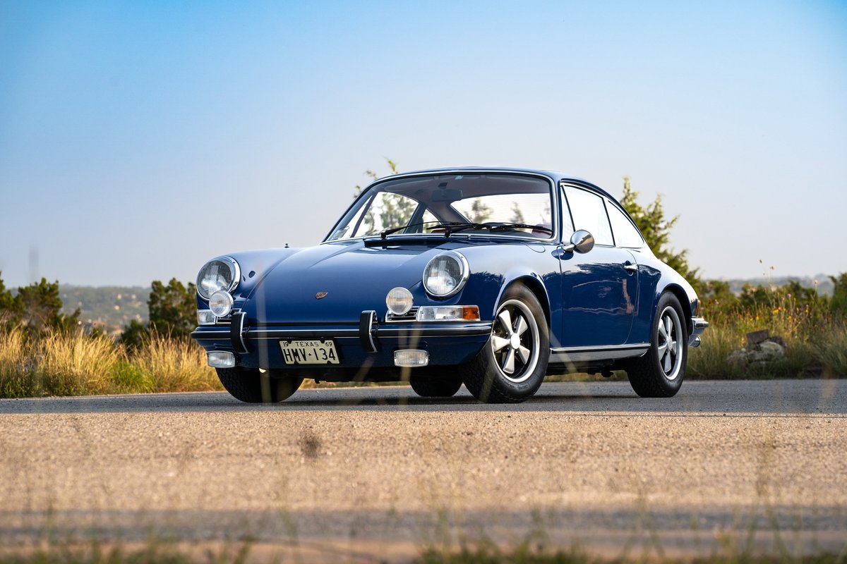 A classic blue 1969 Porsche 911 S Coupe with chrome trim and five-spoke alloy rims.