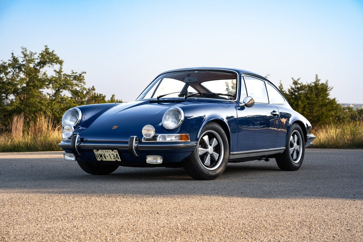 1969 Porsche 911S coupe in Ossi Blue, featuring chrome trim and Fuchs wheels.