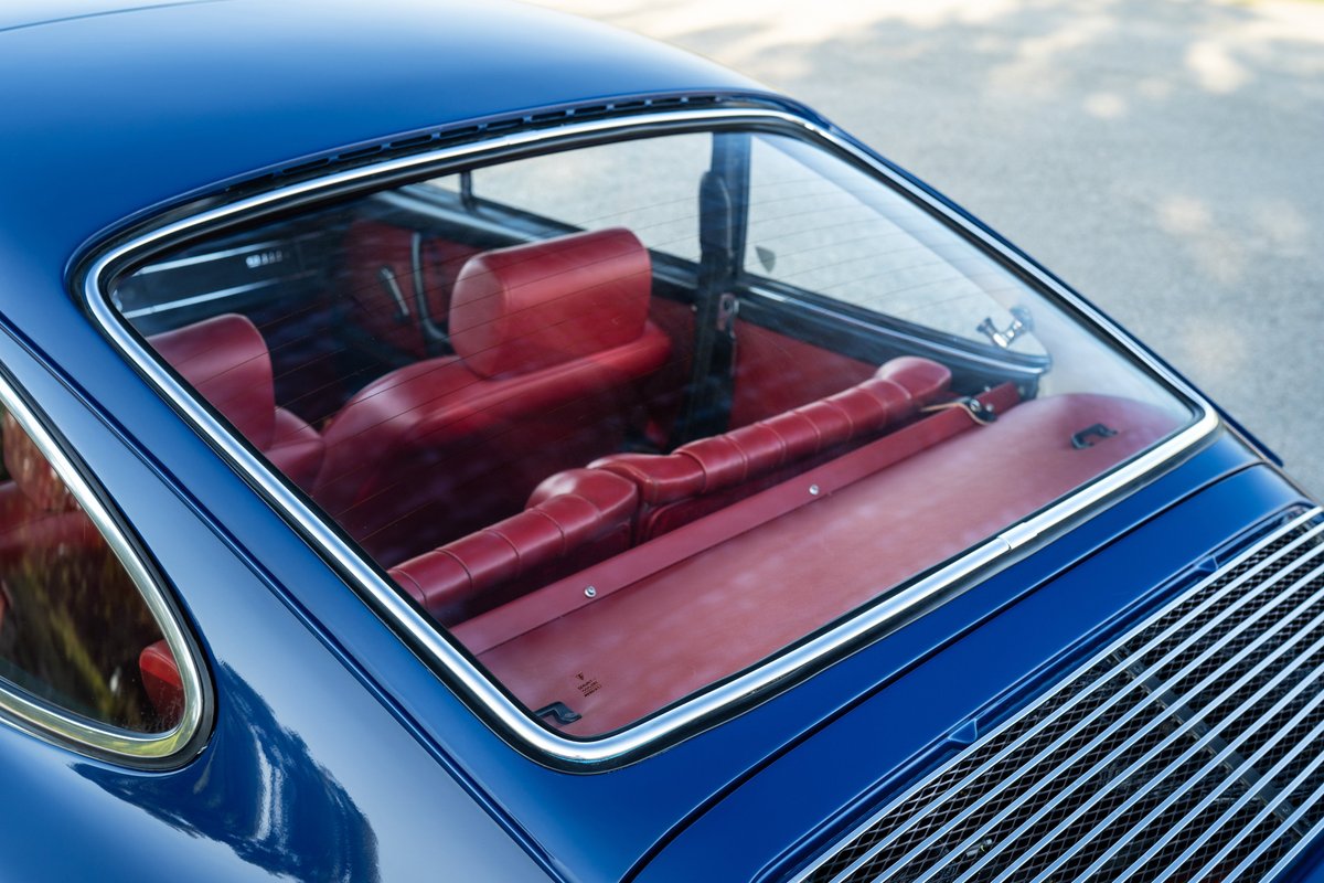 1969 Porsche 911S interior, with red leather seats and rear window.