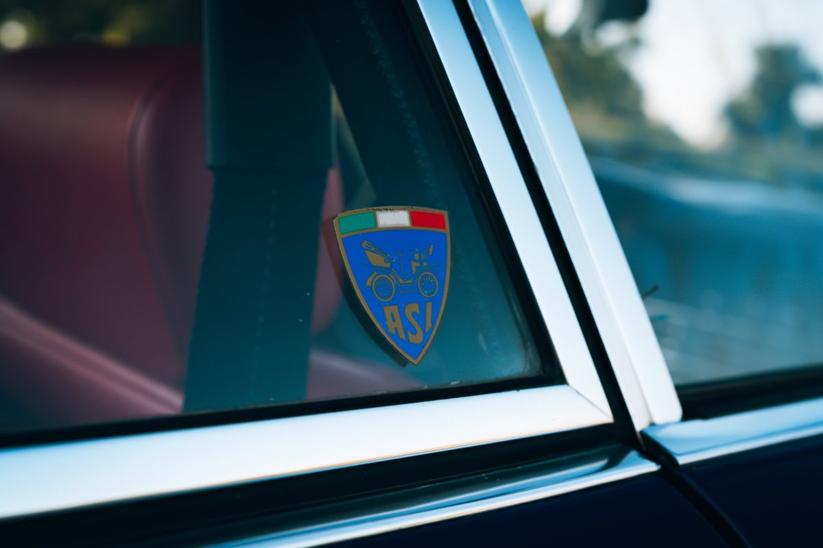 Close-up of a 1969 Porsche 911S with an RSI badge on the window.