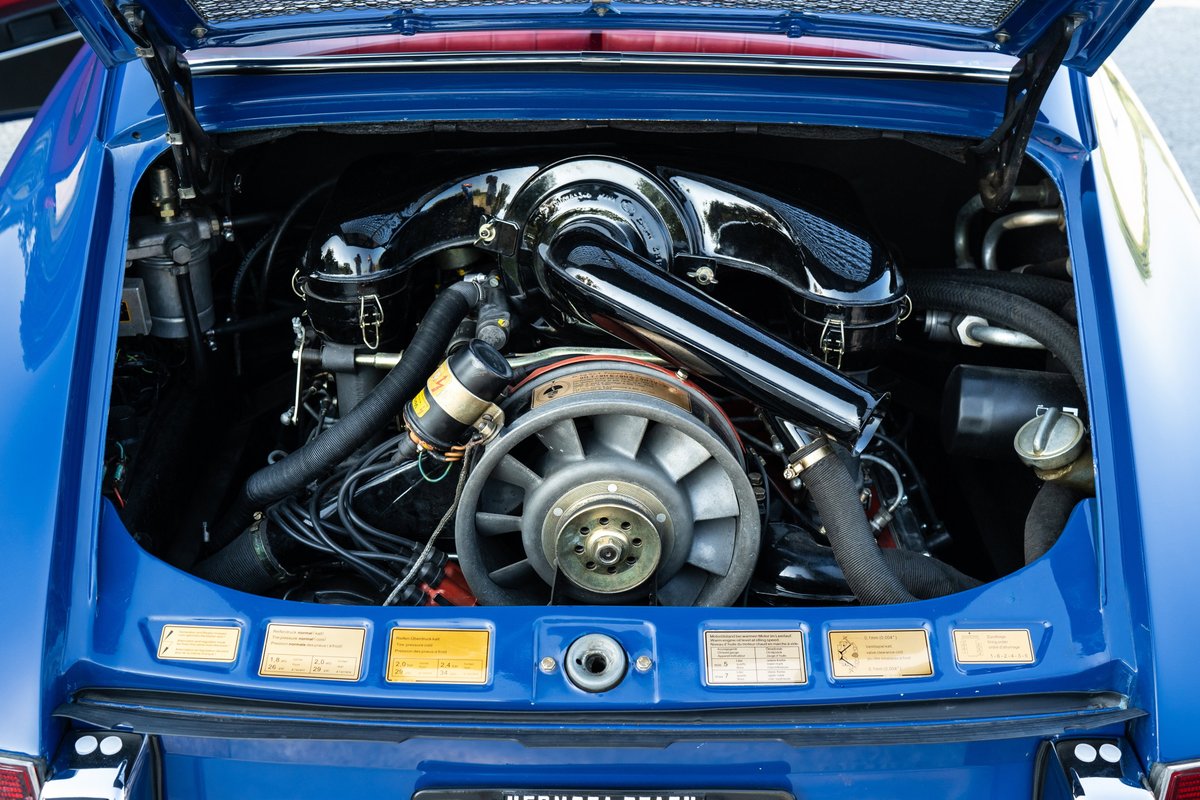 1969 Porsche 911S engine bay in Ossi blue. Air-cooled flat-six engine with cooling fan.