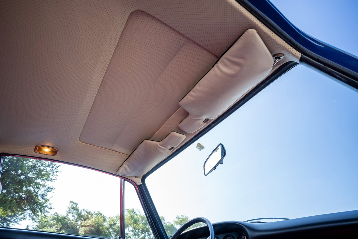 Interior view of a 1969 Porsche 911S showing the headliner, sun visors, and rearview mirror.
