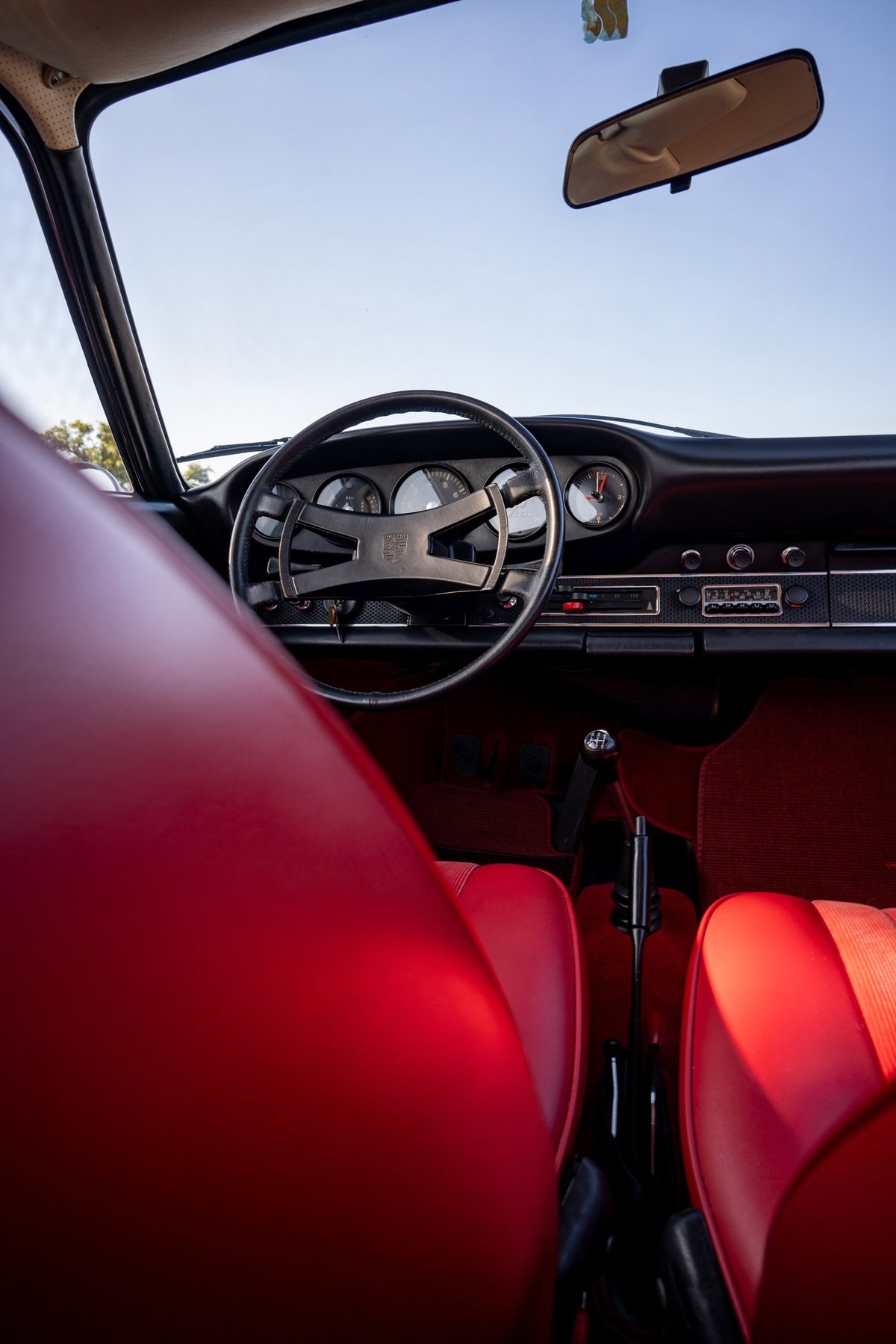 1969 Porsche 911S interior, red leather seats, dashboard, steering wheel.