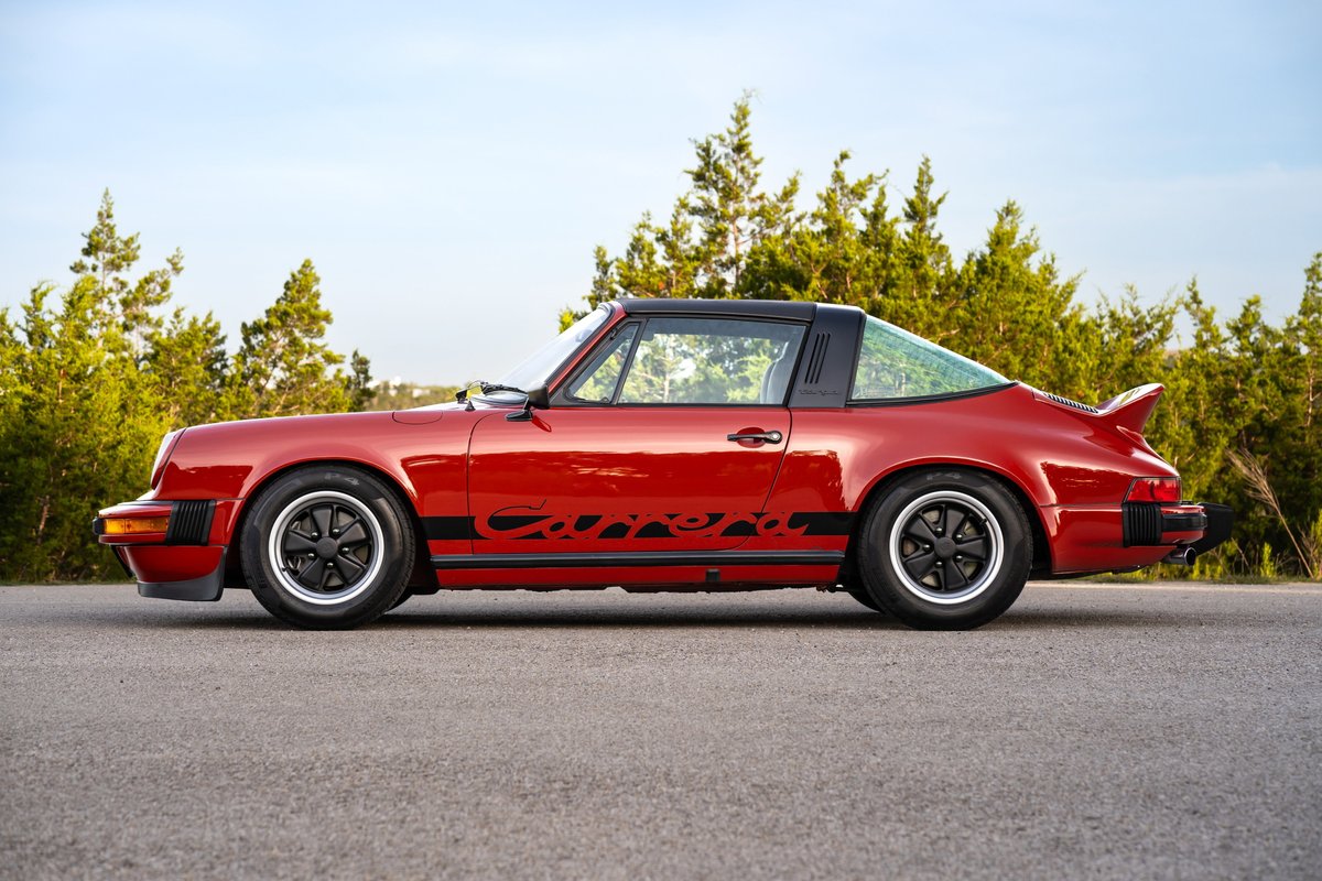 Red 1974 Porsche 911 Carrera Targa with black "Carrera" side livery and Fuchs wheels.