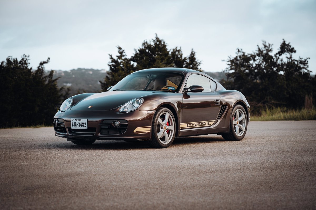 Brown 2008 Porsche Cayman S with gold livery and silver rims.