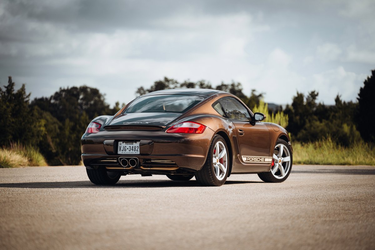 Brown 2008 Porsche Cayman S with Porsche livery and silver alloy rims.