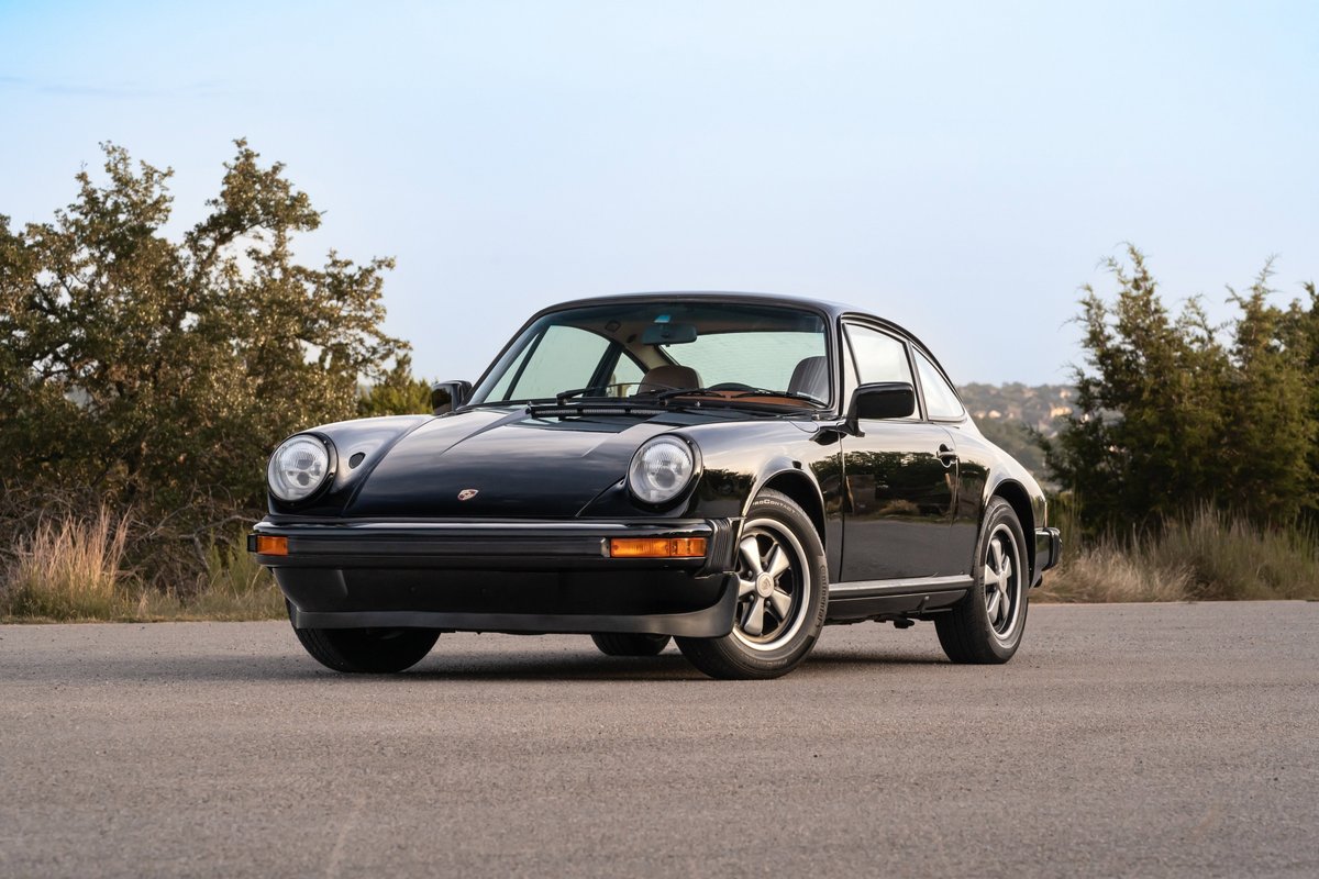 Black 1976 Porsche 911S Sportomatic coupe with Fuchs rims.