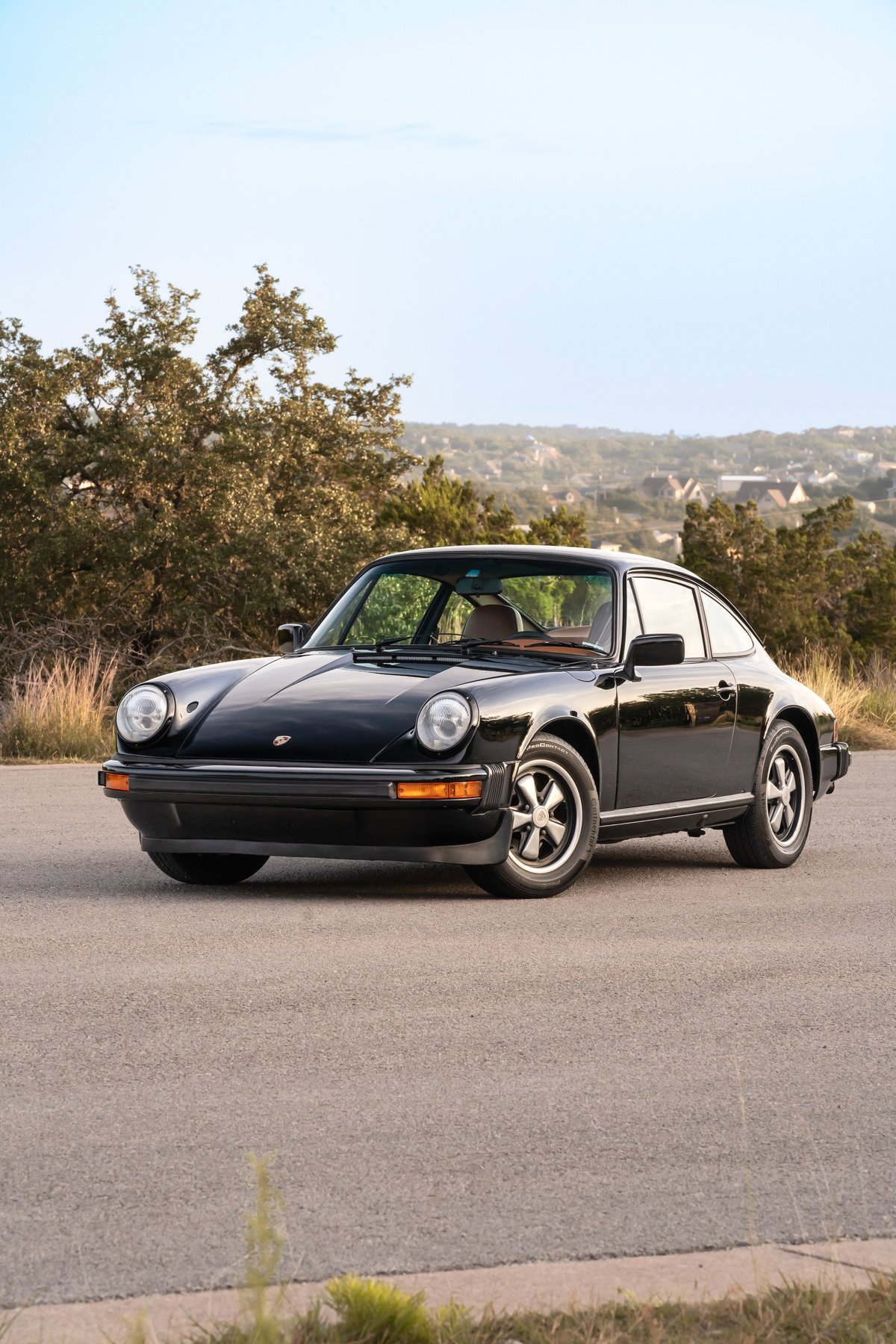 Black 1976 Porsche 911S Sportomatic coupe with Fuchs rims.