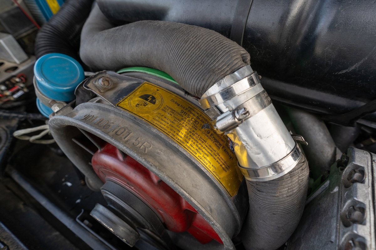 Close-up of the air-cooled engine of a black 1976 Porsche 911S Sportomatic.