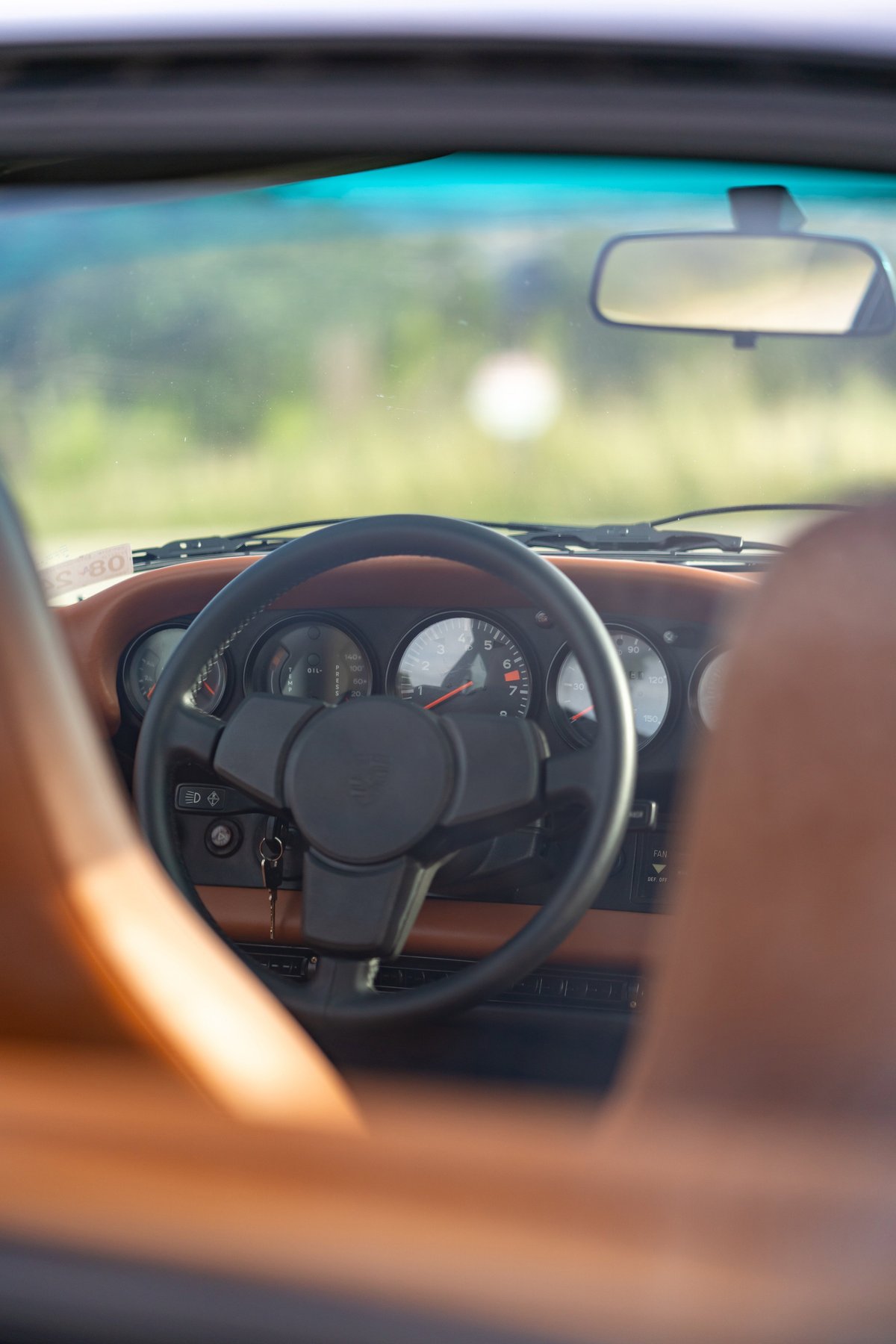 1976 Porsche 911S Sportomatic interior with tan leather trim and classic gauges.