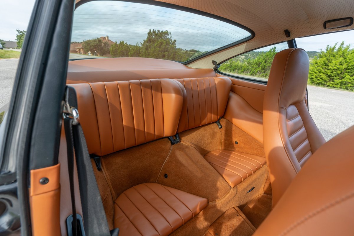 1976 Porsche 911S interior with tan leather sport seats and door trim.