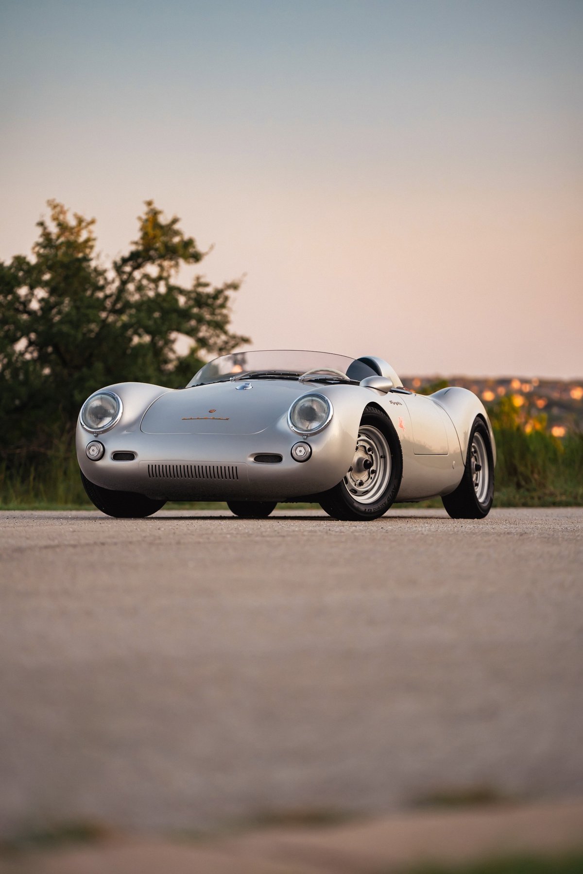 Silver Beck 550 Spyder classic sports car with chrome trim and period-correct rims.