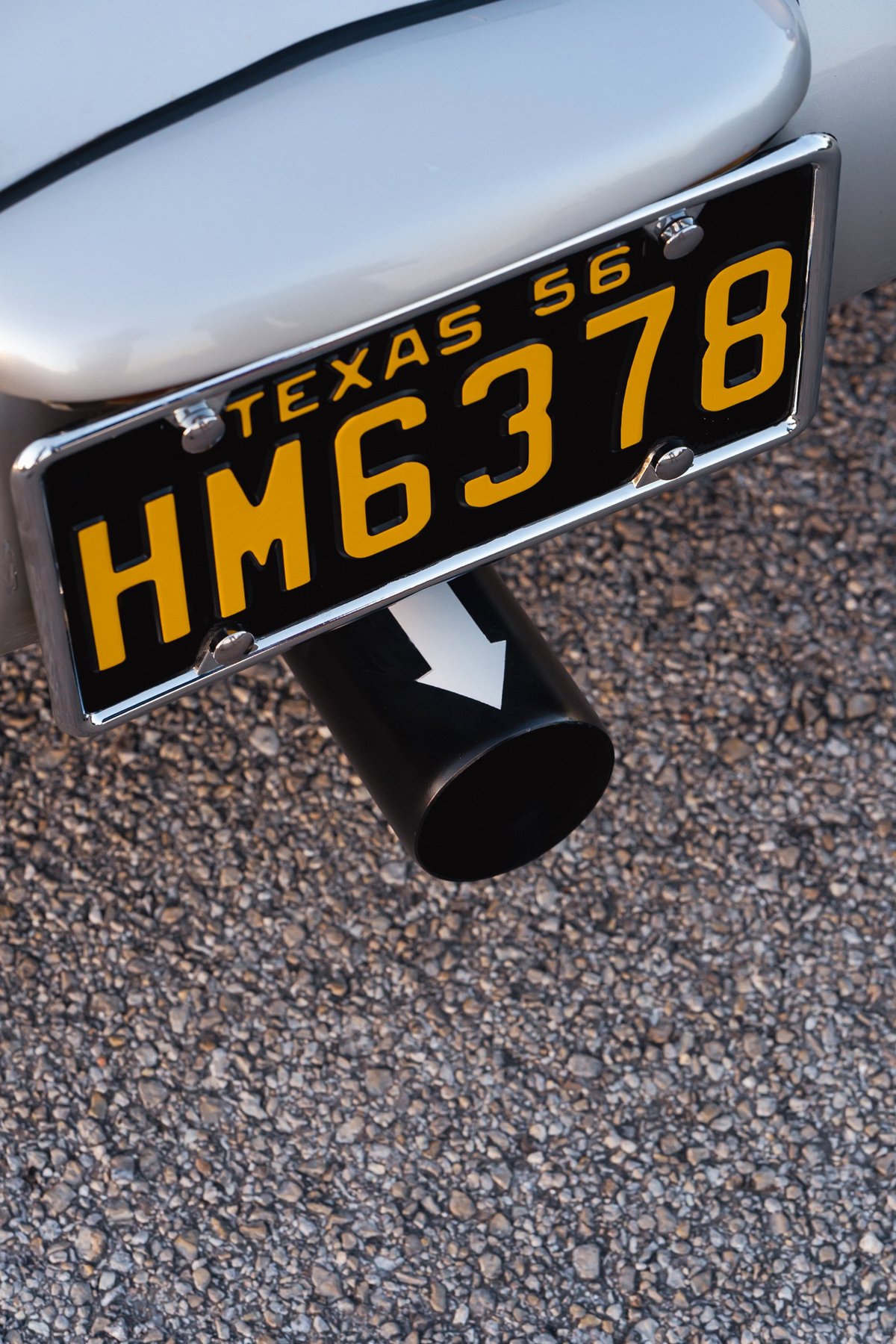 Silver 1956 Beck 550 Spyder with black exhaust tip and Texas license plate.